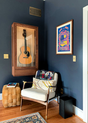 a vintage martin 00-18 12 fret in a american music furniture wall guitar display case