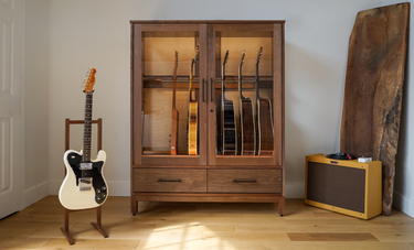 climate controlled guitar display humidor and single guitar stand in a music room 