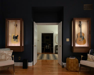 interior design music room photo of two vintage guitars wall mounted and preserved in a beautiful new york city home