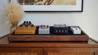 vintage rat pedal, klon centaur gold pedal, union effects, and guitar tuner pedal on a custom walnut pedalboard by american music furniture