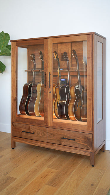 guitar display cabinet in walnut full of luthier-made acoustic instruments being humidified